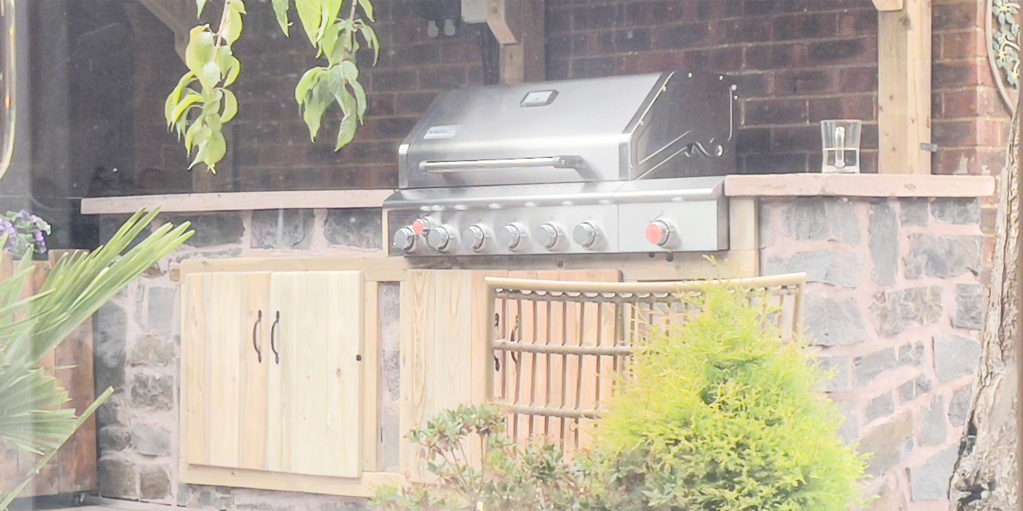 Custom outdoor kitchen with BBQ and prep area by TJ Rose
