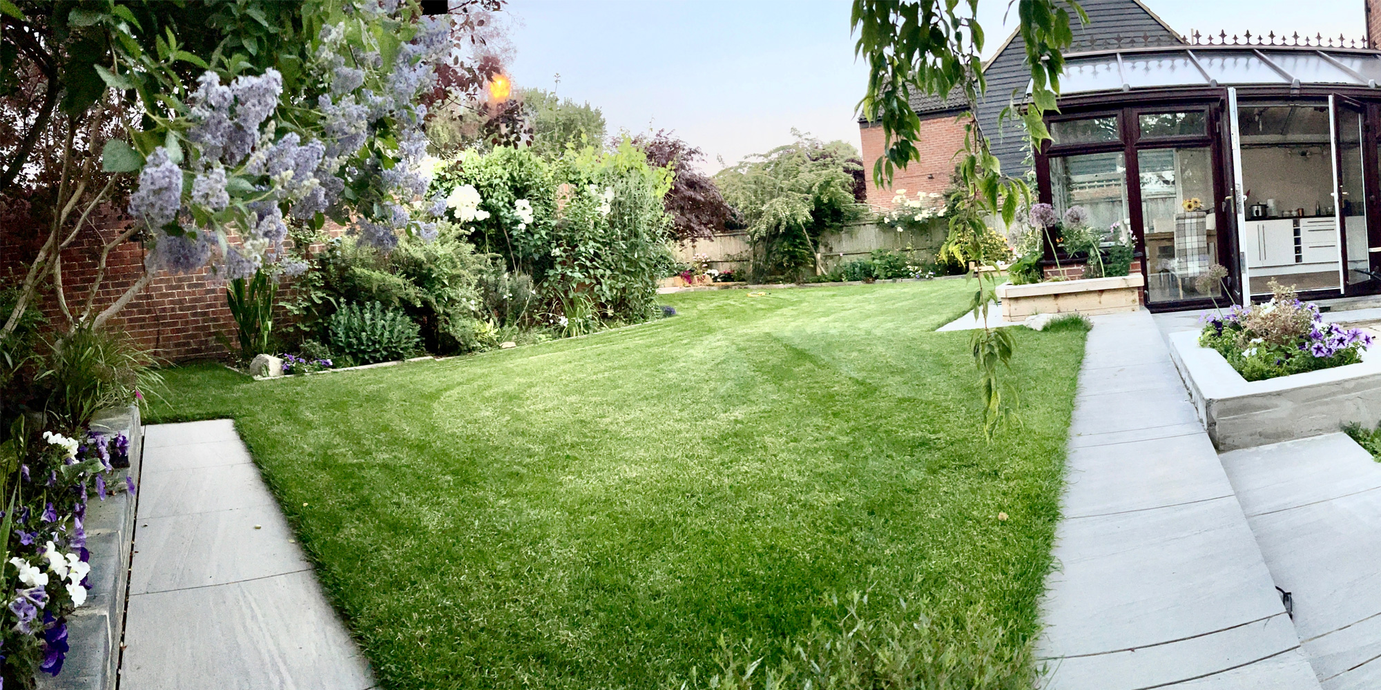 Natural stone patio with raised beds